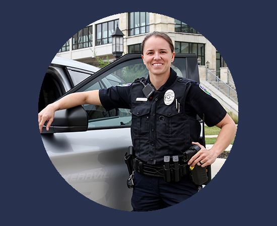 Officer Amanda Ake in fornt of police cruiser
